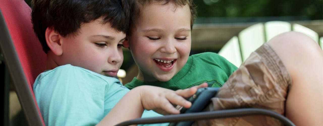 Two boys sharing an iPad outdoors - special education lawyer, South Orange NJ